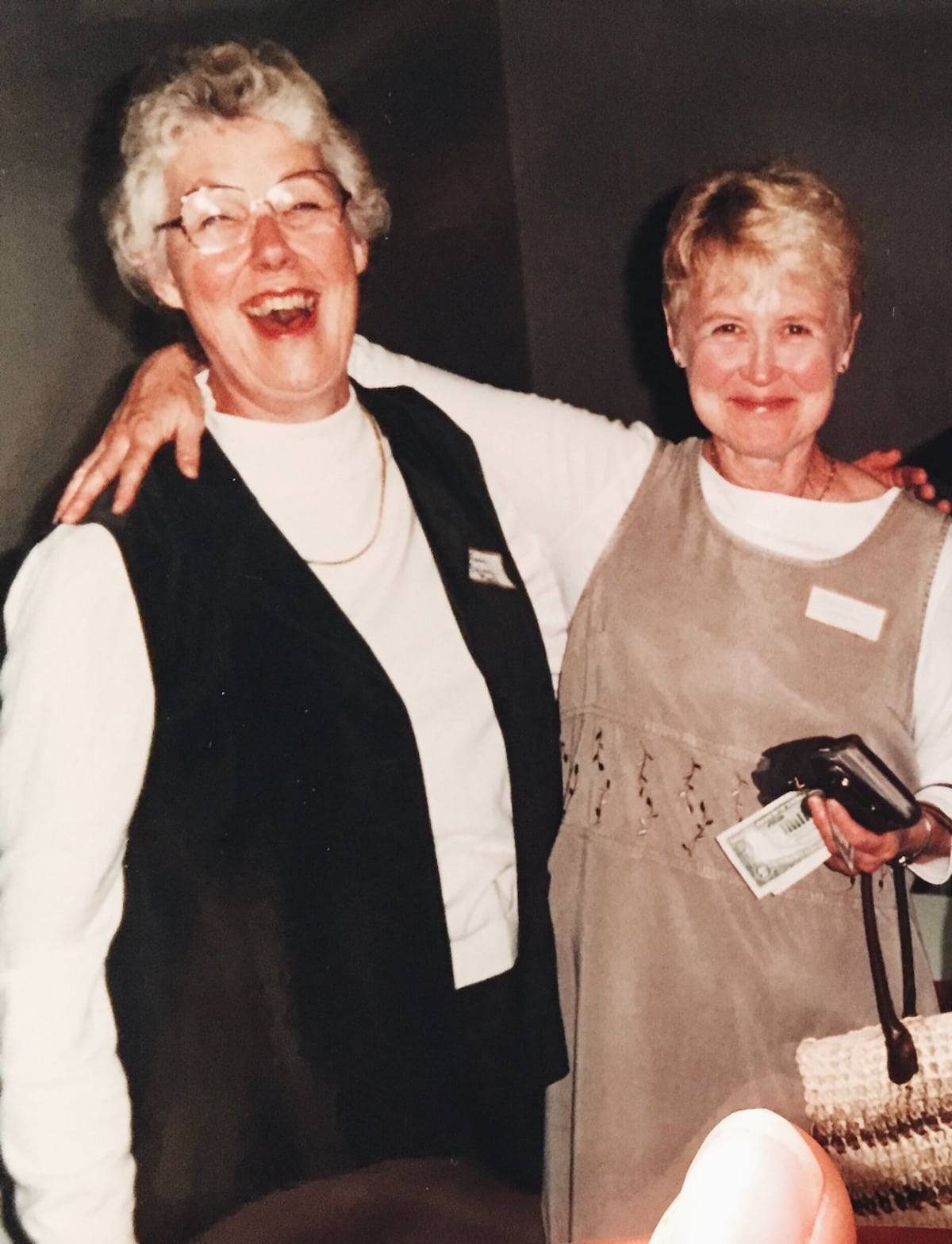 Two women smiling.
