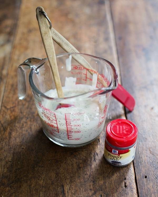 Homemade poppy seed dressing in a measuring cup.