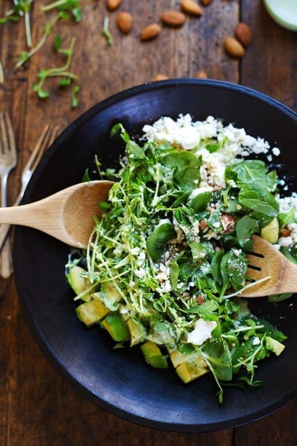 Green Goddess Detox Salad with wooden spoons.