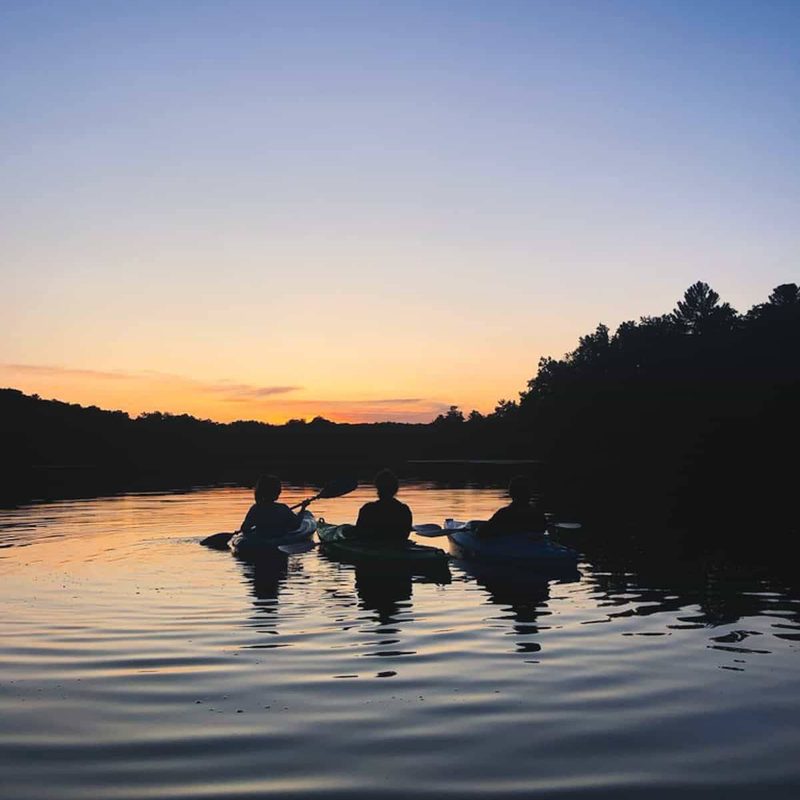 People canoeing at sunset.