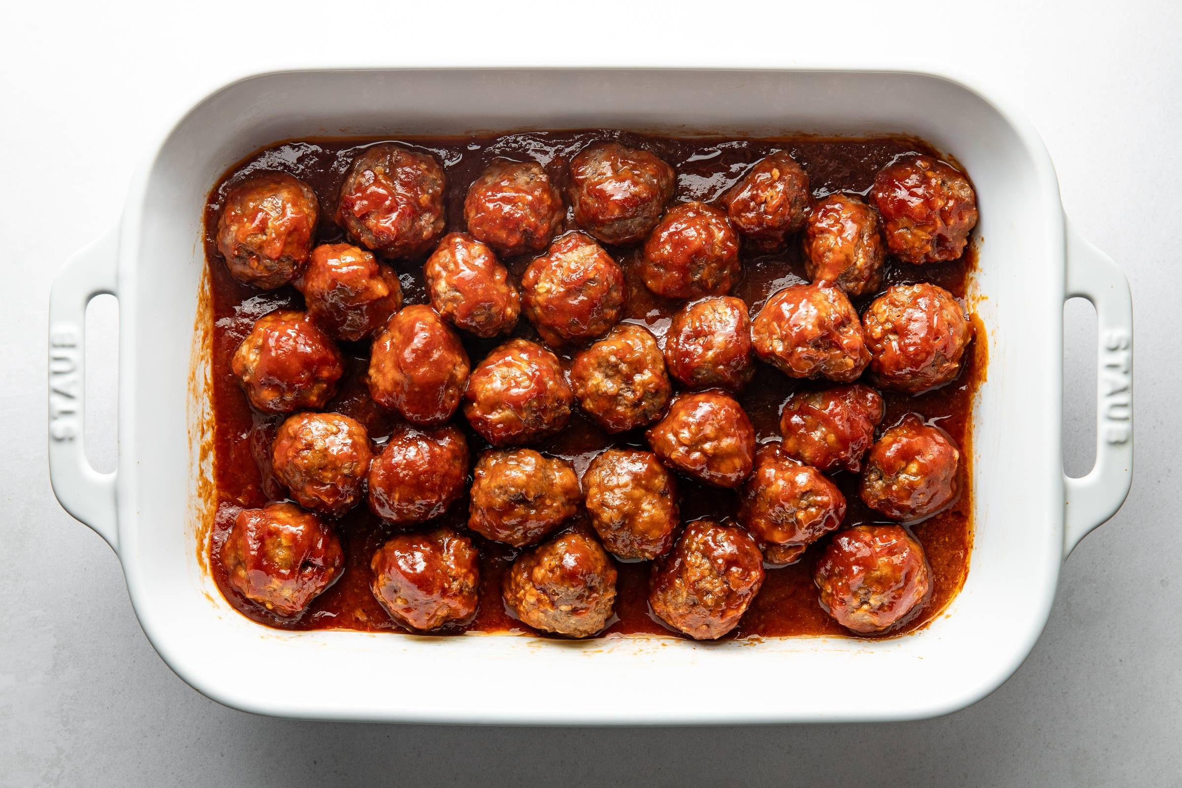 Baked bbq meatballs in a casserole dish.