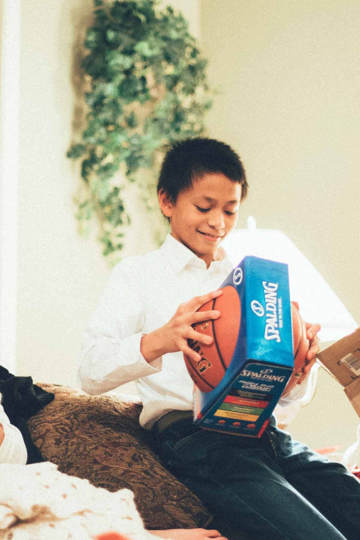 Boy opening a new basketball.