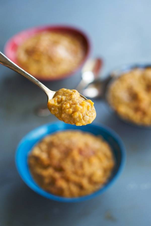 Sweet Potato Lentils in colorful bowls and on a spoon.