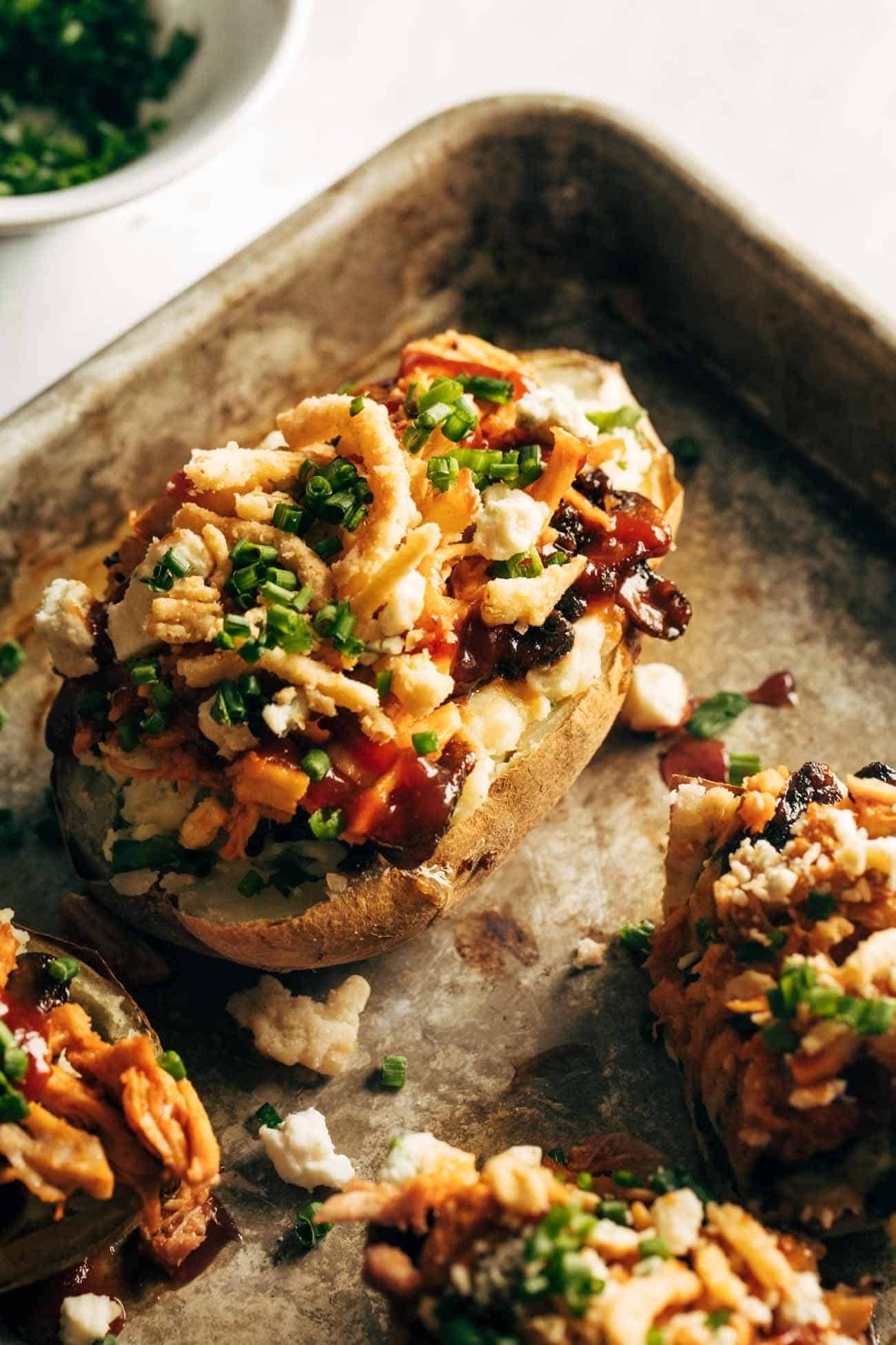 Close-up of Loaded BBQ Baked Potato on a sheet pan.
