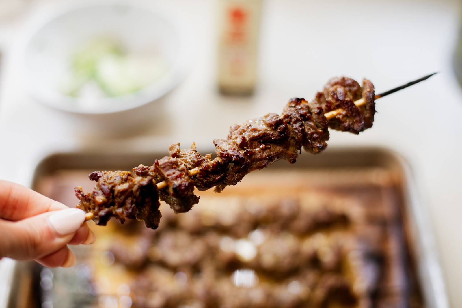 Broiled steak strips on a skewer.