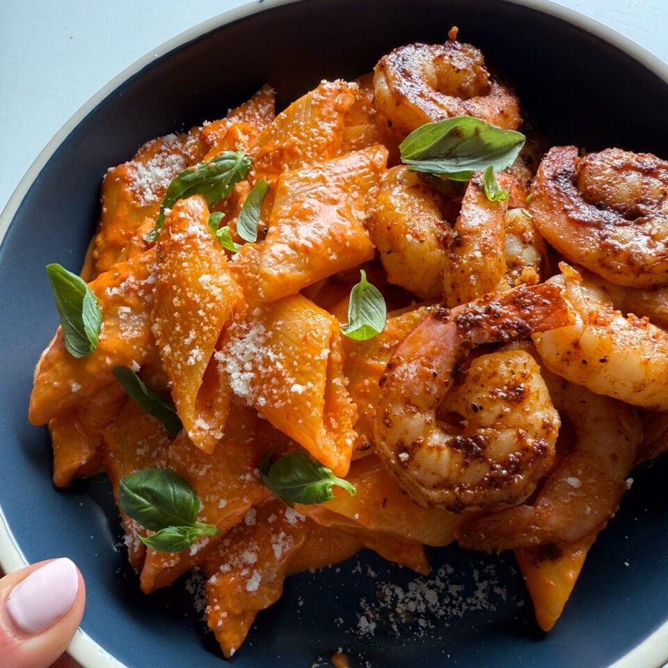 Roasted red pepper pasta and shrimp in a bowl.