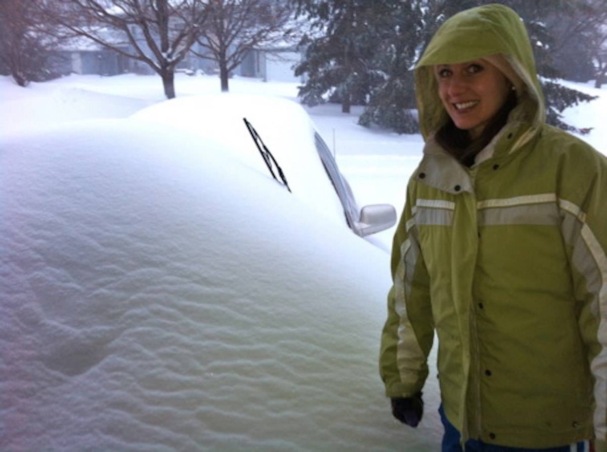 Large sheets of snow covering a car in Minnesota.