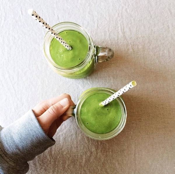 Green smoothies with straws in jars.
